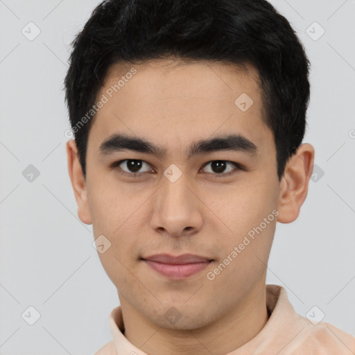 Joyful white young-adult male with short  black hair and brown eyes