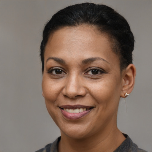 Joyful latino adult female with short  brown hair and brown eyes