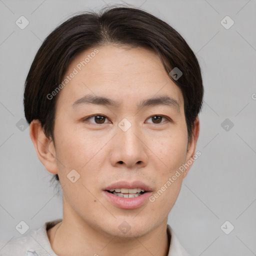 Joyful asian young-adult male with short  brown hair and brown eyes