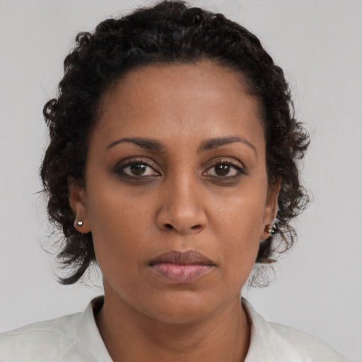 Neutral black young-adult female with medium  brown hair and brown eyes