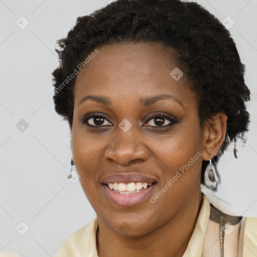 Joyful black young-adult female with short  brown hair and brown eyes