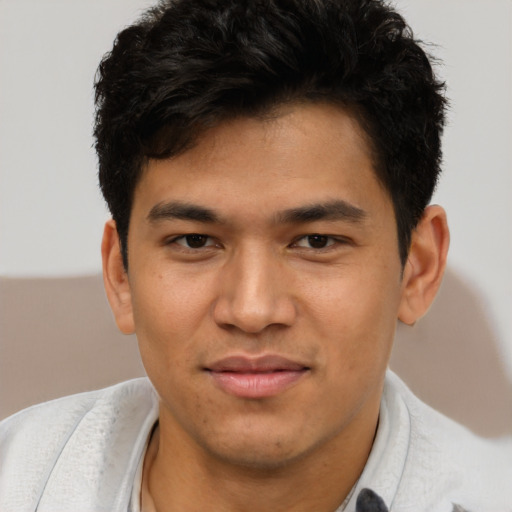 Joyful asian young-adult male with short  brown hair and brown eyes