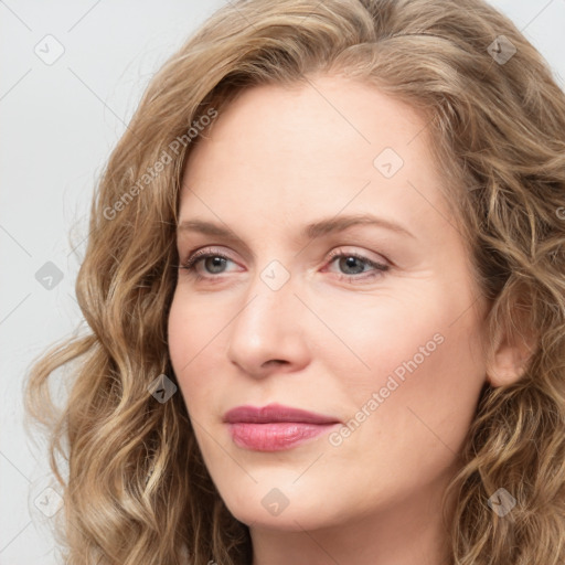 Joyful white young-adult female with long  brown hair and blue eyes