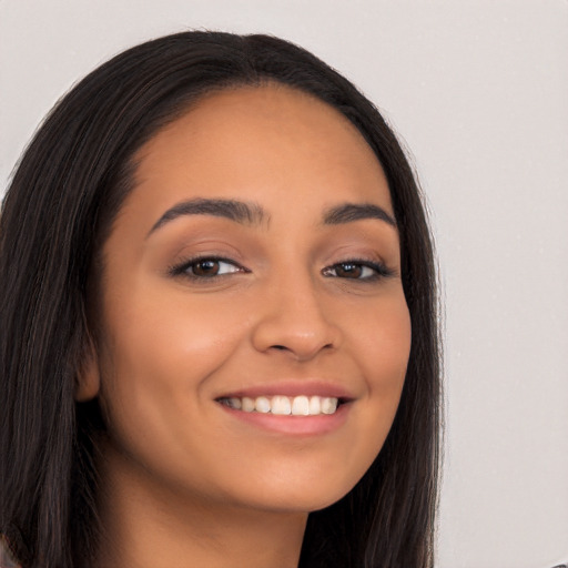 Joyful latino young-adult female with long  black hair and brown eyes