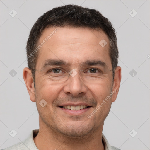 Joyful white adult male with short  brown hair and brown eyes