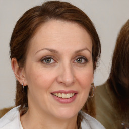 Joyful white adult female with medium  brown hair and grey eyes