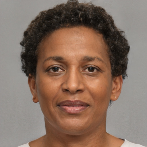 Joyful black adult female with short  brown hair and brown eyes