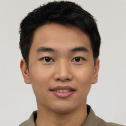 Joyful asian young-adult male with short  black hair and brown eyes