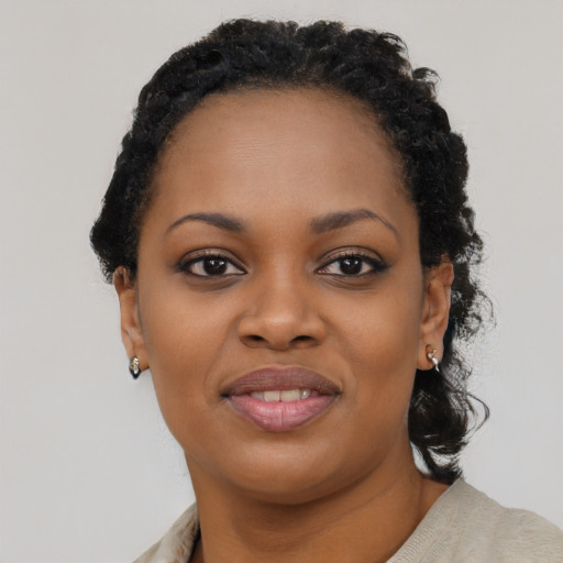 Joyful black young-adult female with medium  black hair and brown eyes