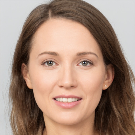 Joyful white young-adult female with long  brown hair and brown eyes