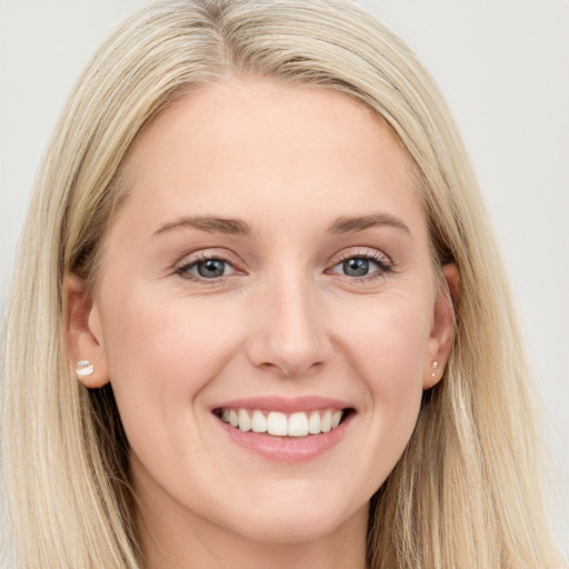 Joyful white young-adult female with long  brown hair and blue eyes