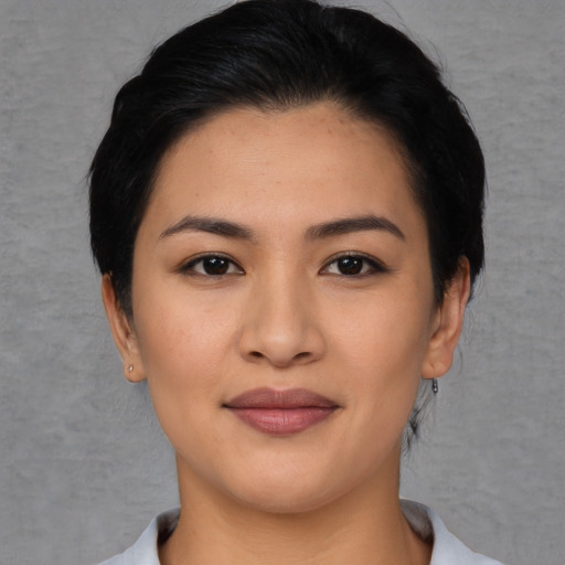 Joyful asian young-adult female with short  black hair and brown eyes