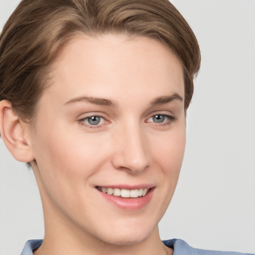 Joyful white young-adult female with short  brown hair and grey eyes