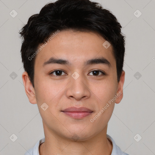 Joyful asian young-adult male with short  brown hair and brown eyes