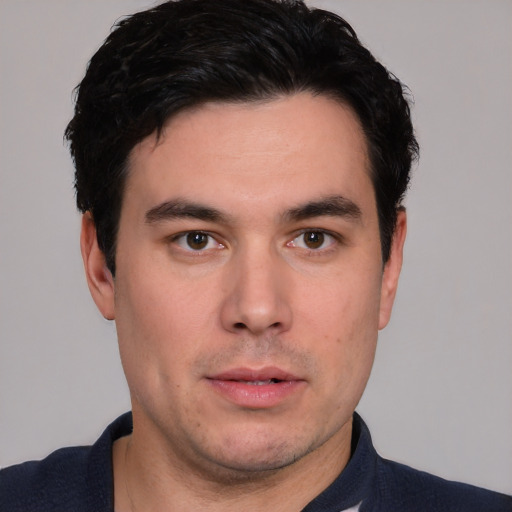 Neutral white young-adult male with short  black hair and brown eyes