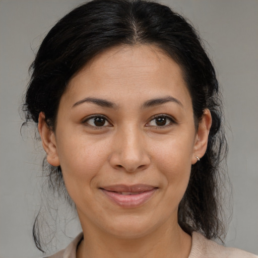 Joyful latino young-adult female with medium  brown hair and brown eyes