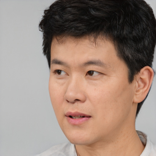 Neutral asian young-adult male with short  black hair and brown eyes