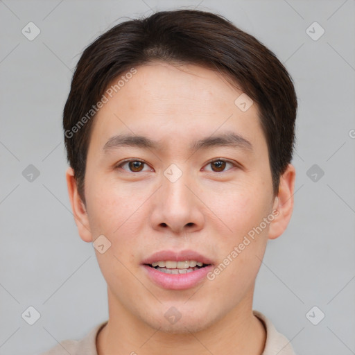 Joyful asian young-adult male with short  brown hair and brown eyes