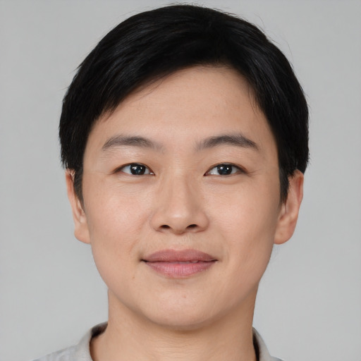 Joyful asian young-adult male with short  black hair and brown eyes