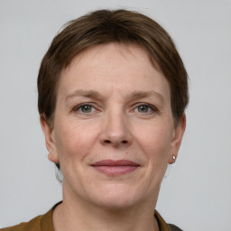 Joyful white adult female with short  brown hair and grey eyes