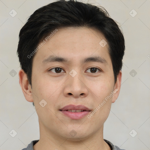 Joyful asian young-adult male with short  brown hair and brown eyes