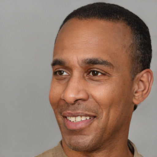 Joyful latino adult male with short  brown hair and brown eyes