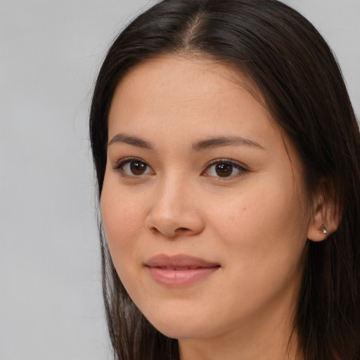 Joyful asian young-adult female with long  brown hair and brown eyes