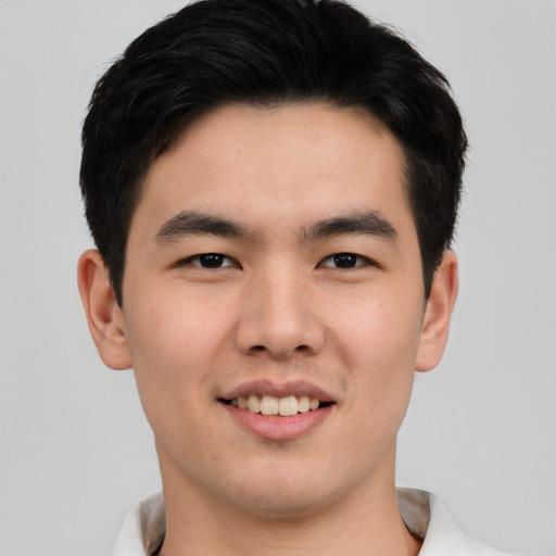 Joyful asian young-adult male with short  black hair and brown eyes
