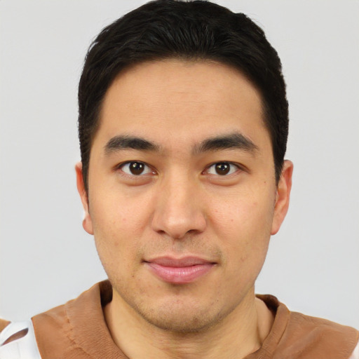 Joyful latino young-adult male with short  brown hair and brown eyes