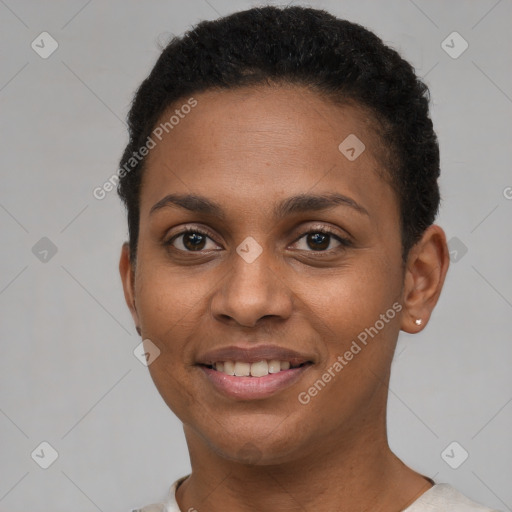 Joyful black young-adult female with short  brown hair and brown eyes