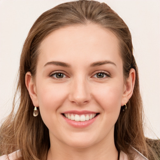 Joyful white young-adult female with long  brown hair and grey eyes