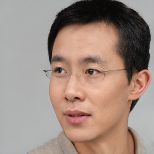 Neutral asian adult male with short  black hair and brown eyes