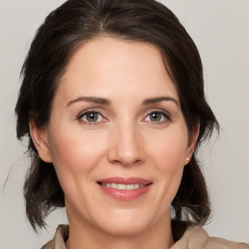 Joyful white adult female with medium  brown hair and brown eyes