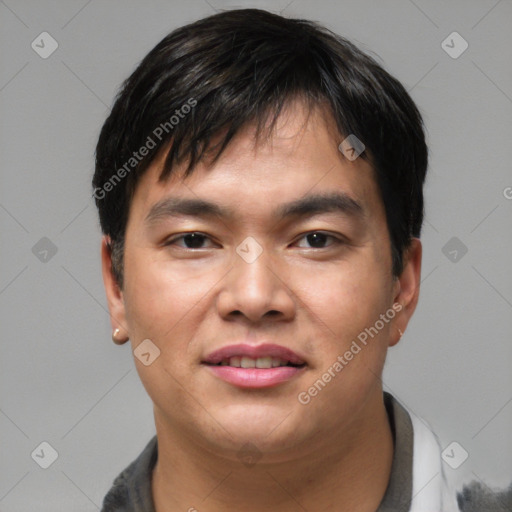 Joyful asian young-adult male with short  brown hair and brown eyes