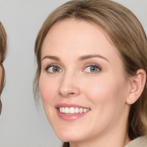 Joyful white young-adult female with medium  brown hair and blue eyes