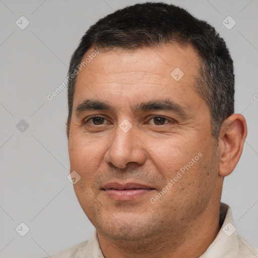 Joyful white adult male with short  black hair and brown eyes