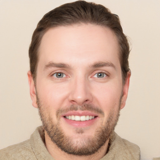 Joyful white young-adult male with short  brown hair and grey eyes