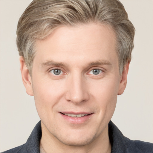 Joyful white adult male with short  brown hair and grey eyes