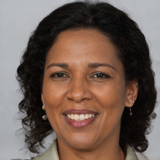 Joyful latino adult female with long  brown hair and brown eyes