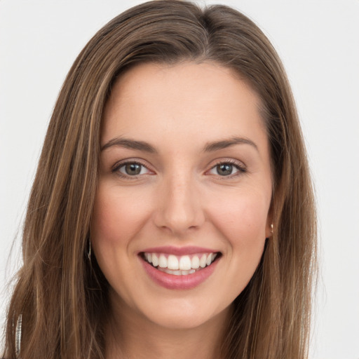 Joyful white young-adult female with long  brown hair and green eyes