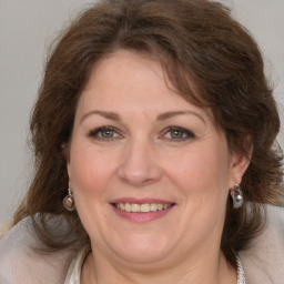 Joyful white adult female with medium  brown hair and grey eyes