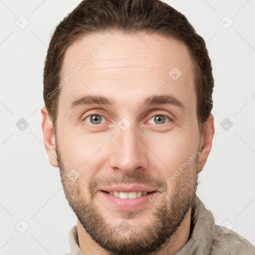 Joyful white young-adult male with short  brown hair and grey eyes