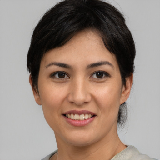 Joyful asian young-adult female with short  black hair and brown eyes