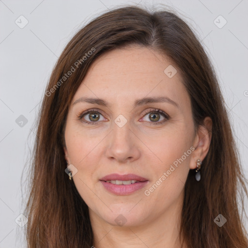 Joyful white adult female with long  brown hair and brown eyes