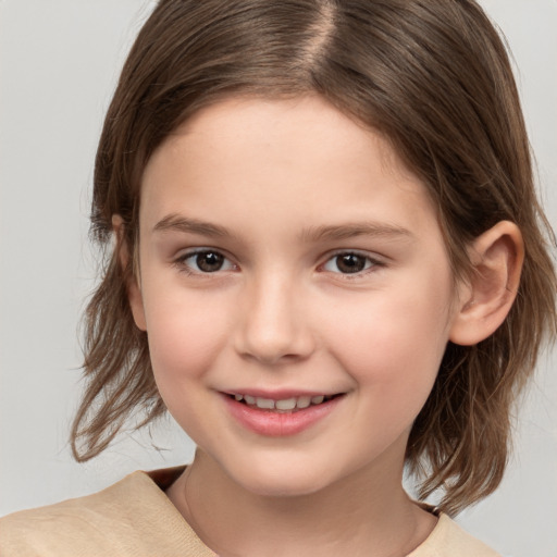 Joyful white child female with medium  brown hair and brown eyes