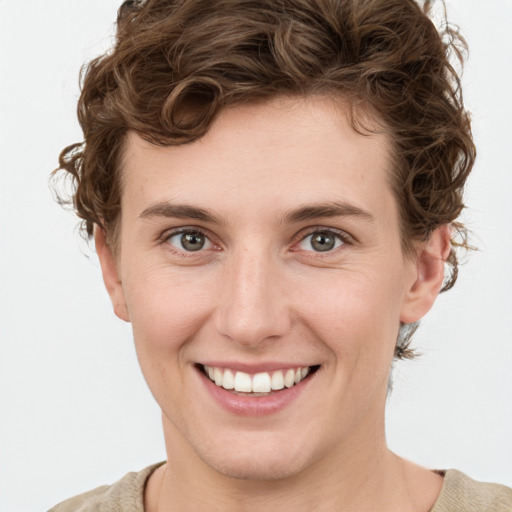 Joyful white young-adult female with short  brown hair and green eyes