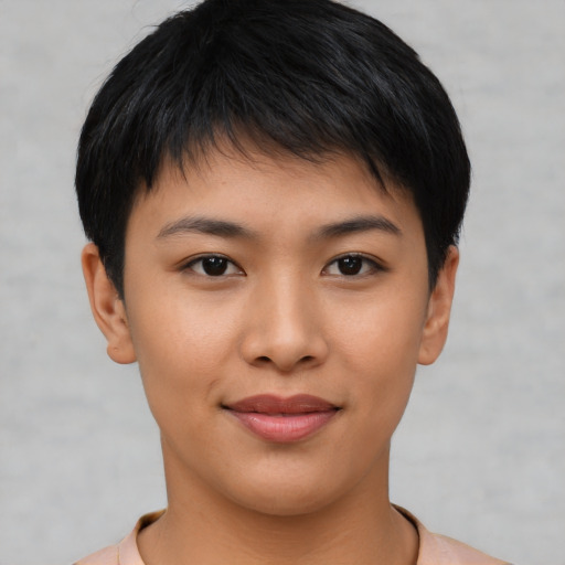 Joyful asian young-adult female with short  brown hair and brown eyes