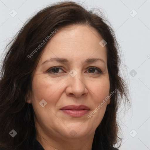 Joyful white adult female with long  brown hair and brown eyes