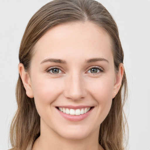 Joyful white young-adult female with long  brown hair and grey eyes