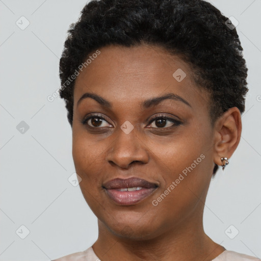 Joyful black young-adult female with short  black hair and brown eyes